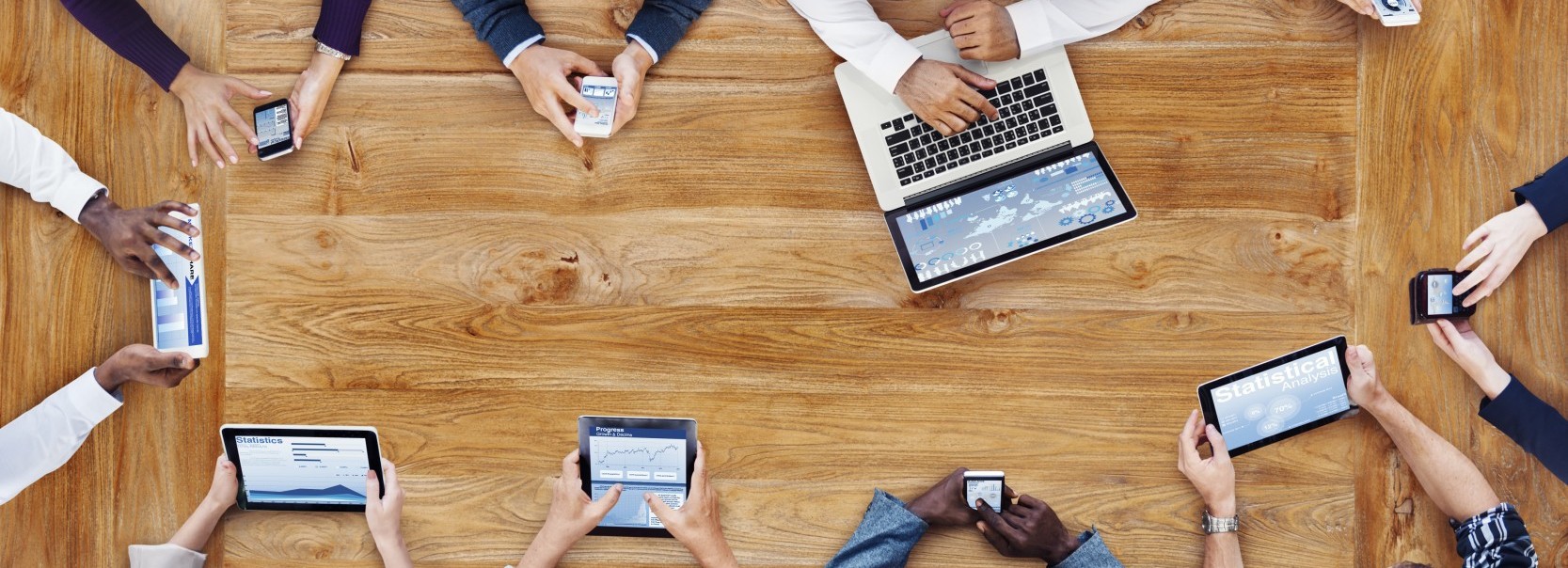 Overhead view of people working with mobile and computing devices