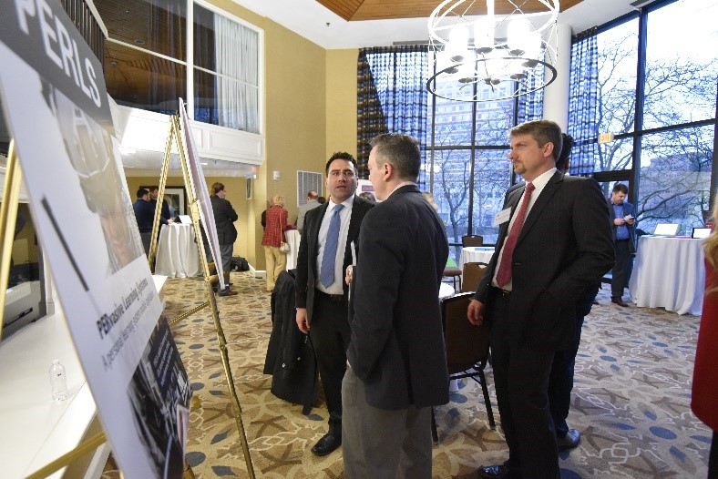 Participants reviewing project poster